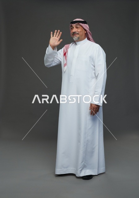 Saudi Man in Traditional Dress Waving in Studio