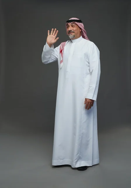 Saudi Man in Traditional Dress Waving in Studio