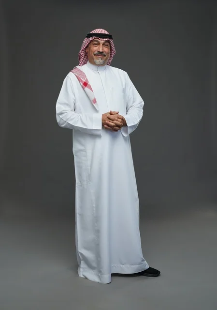 Saudi Man in Traditional National Dress on Grey Background