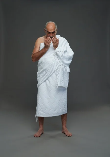 Saudi Man in Ihram Clothing Praying in Studio
