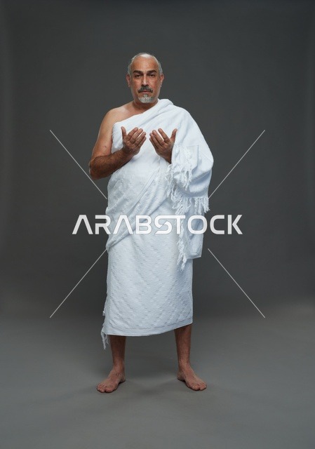 رجل سعودي بملابس الإحرام يدعو في الاستوديو