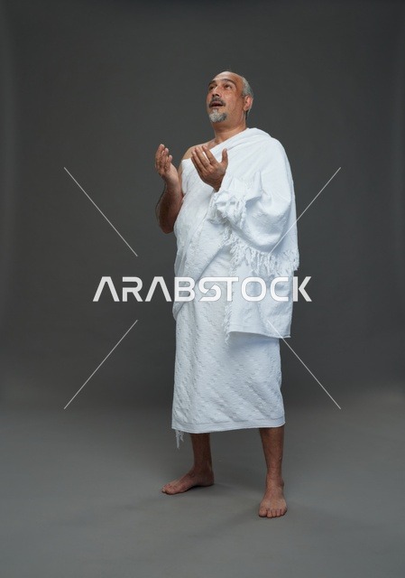 رجل سعودي بملابس الإحرام يدعو في الاستوديو