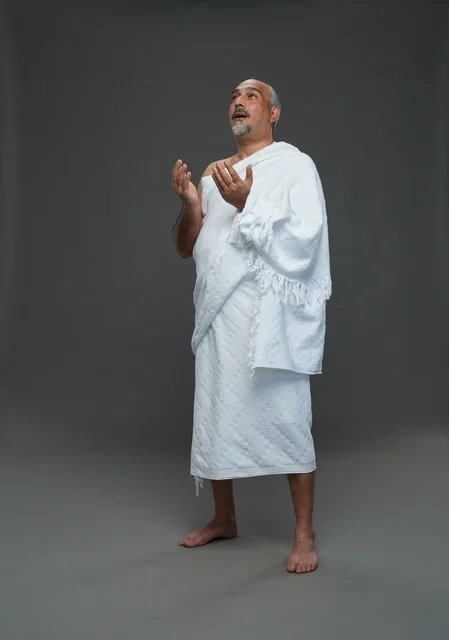 Saudi Man in Ihram Clothing Praying in Studio