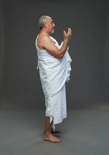 Saudi Man in White Ihram Praying During Hajj Rituals