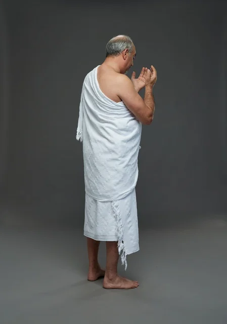 Saudi Man in Ihram Clothing Praying in Studio