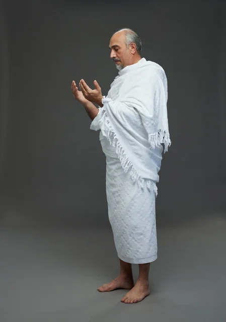 Saudi Man in Ihram Clothes Praying in Studio Profile