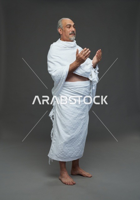 رجل سعودي بملابس الإحرام يدعو في الاستوديو