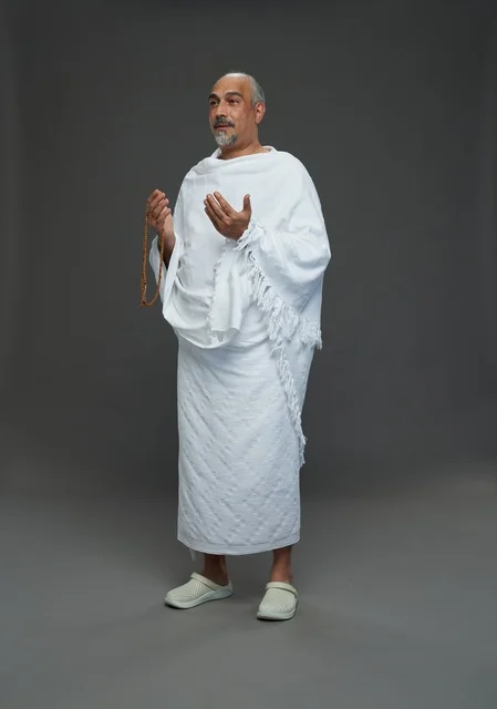 Saudi Man in Ihram Clothing Praying for Hajj