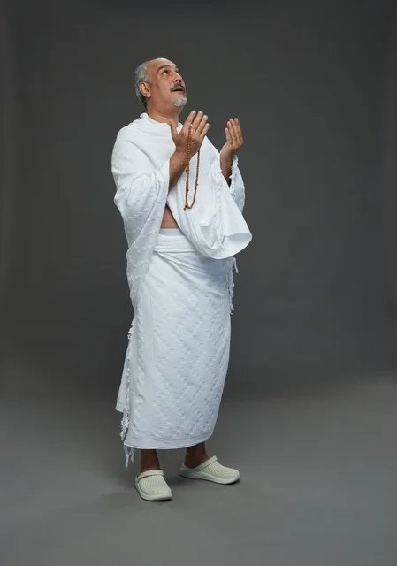 Saudi Man in Ihram Praying with Misbaha