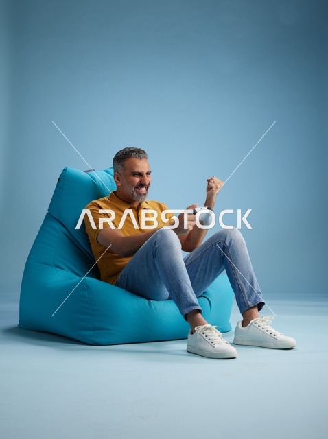 Saudi Man Playing Video Games on Bean Bag Chair