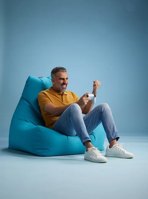Saudi Man Playing Video Games on Bean Bag Chair