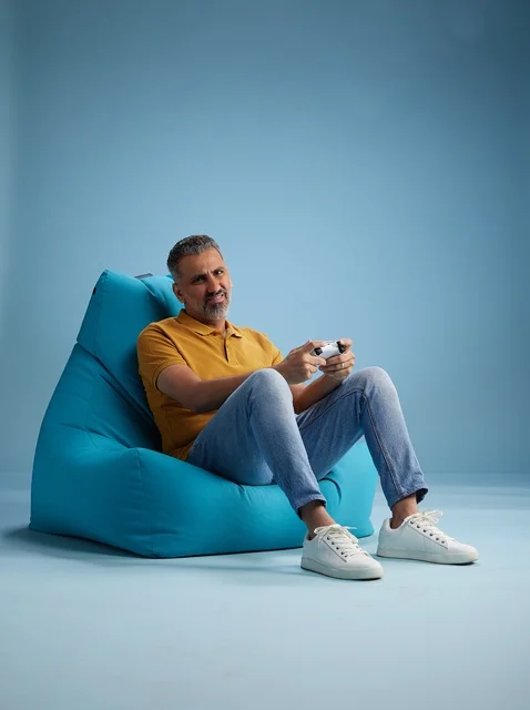 Saudi Man Gaming on Bean Bag with Controller
