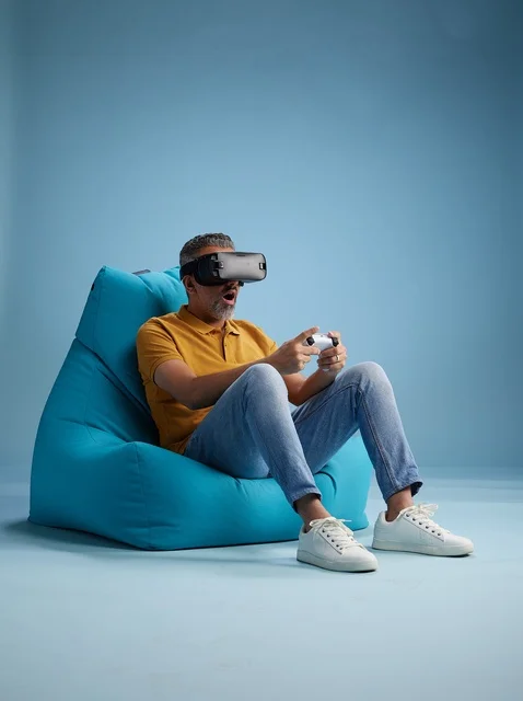 Saudi Man Using VR Headset on Blue Bean Bag