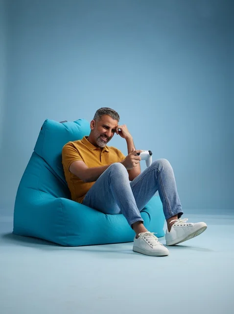 Saudi Man Playing Video Games on Blue Bean Bag