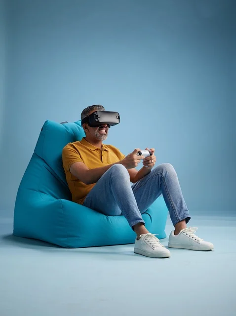 Saudi Man Using Virtual Reality Headset on Bean Bag