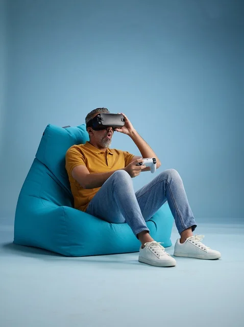 Saudi Man Wearing VR Headset Playing Games on Bean Bag