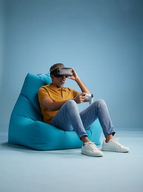 Saudi Man Playing Virtual Reality Games on Beanbag
