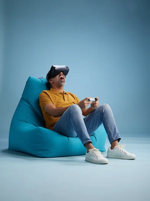 Saudi Man Using Virtual Reality Headset on Bean Bag