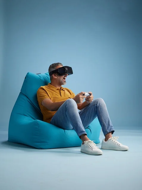 Saudi Man Gaming with VR Headset on Bean Bag