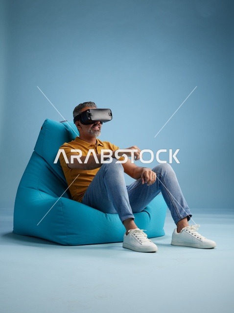 Saudi Man Using VR Headset on Blue Bean Bag
