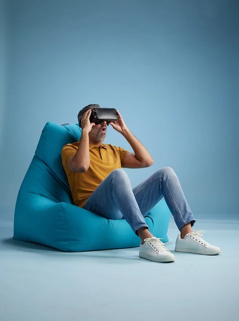 Saudi Man Using VR Headset on Bean Bag Chair