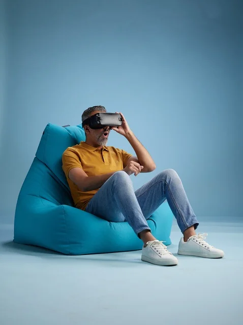 Saudi Man Using VR Headset on Blue Bean Bag
