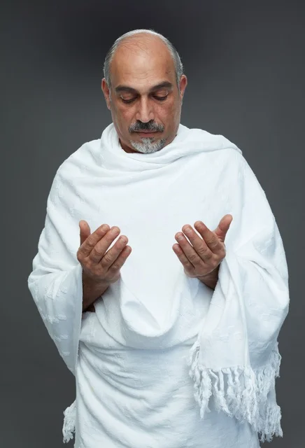 Saudi Man in Ihram Praying During Hajj or Umrah