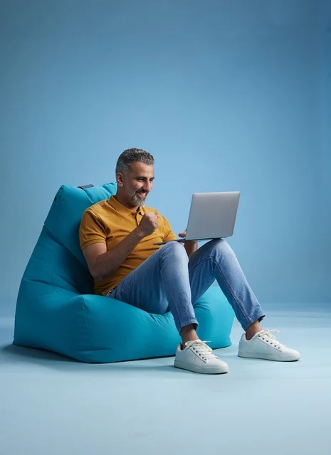 Saudi Man Working on Laptop on Bean Bag
