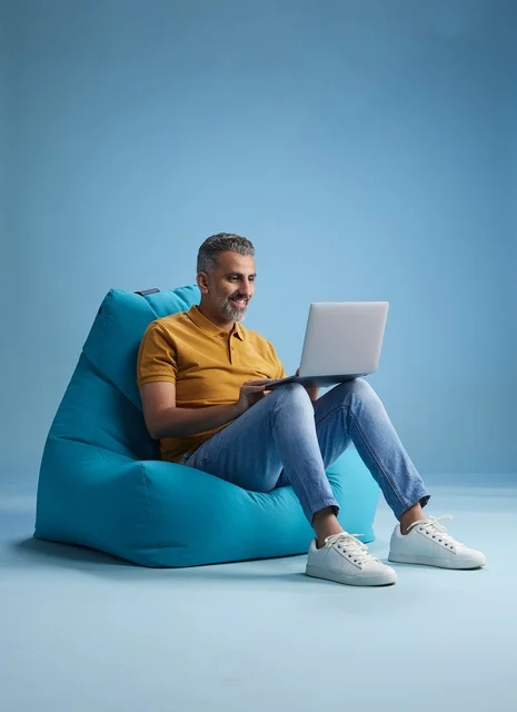 Saudi Man Working on Laptop on Bean Bag