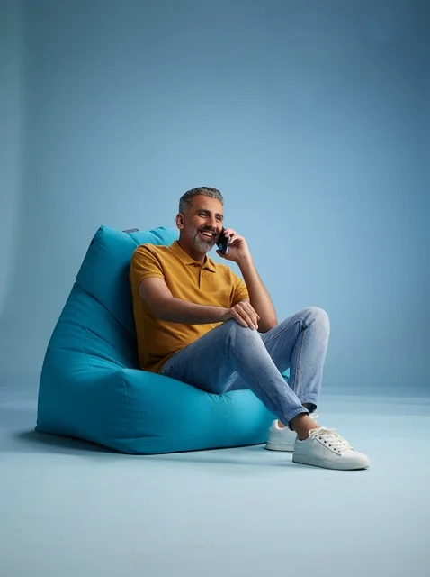 Saudi Man Talking on Mobile Phone on Blue Bean Bag