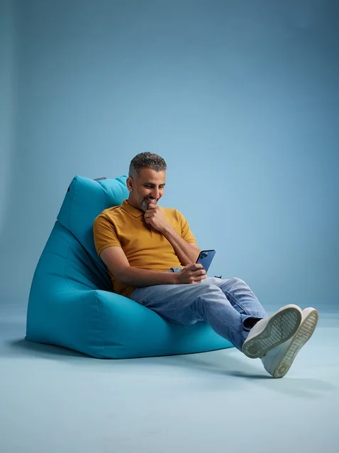 Saudi Man on Bean Bag Using Smartphone Studio