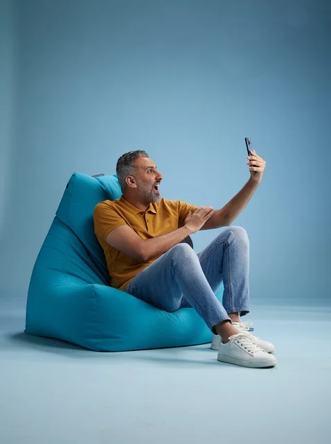 Saudi Man Taking Selfie on Bean Bag Chair in Studio