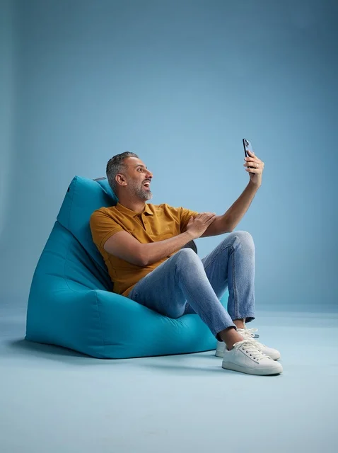 Saudi Man Taking Selfie on Blue Bean Bag Chair