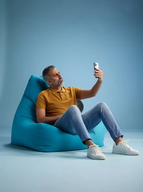 Saudi Man Taking Selfie on Bean Bag Chair in Studio