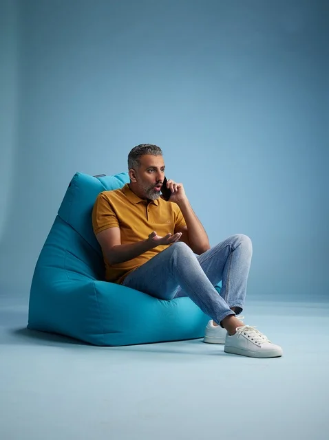 Saudi Man on Bean Bag Talking on Mobile Phone