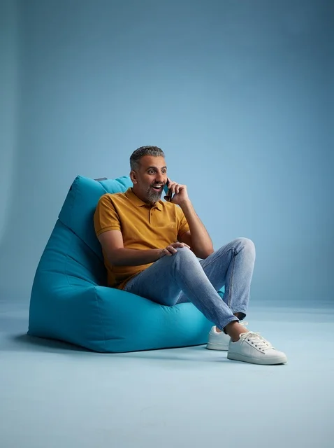 Saudi Man Talking on Phone Sitting on Bean Bag