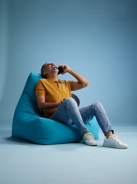 Saudi Man Talking on Phone on Blue Bean Bag