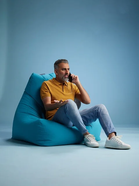 Saudi Man Talking on Phone Sitting on Bean Bag