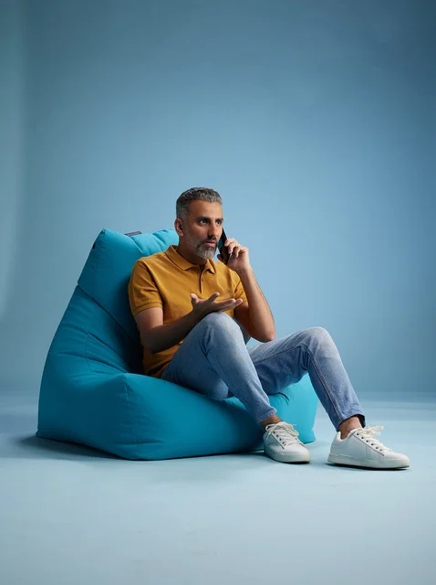 Saudi Man Talking on Phone on Bean Bag Chair