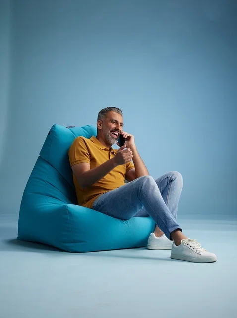 Saudi Man Talking on Phone on Bean Bag Chair Studio