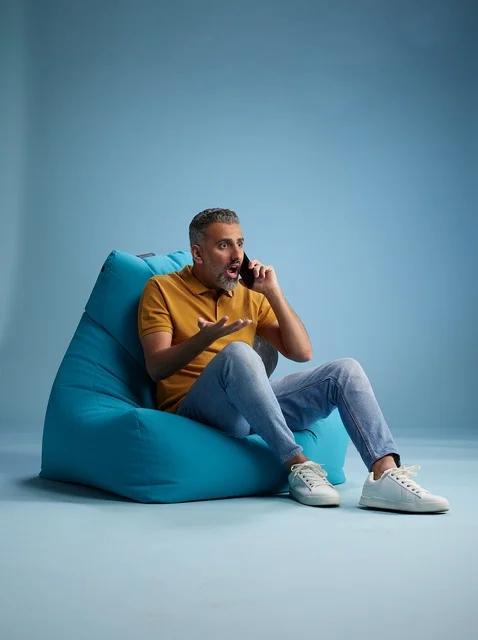 Surprised Saudi Man on Bean Bag Talking on Phone