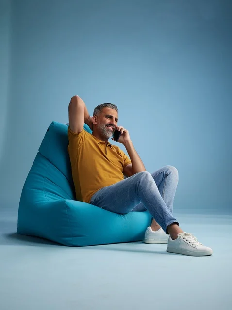 Saudi Man Talking on Phone on Blue Bean Bag