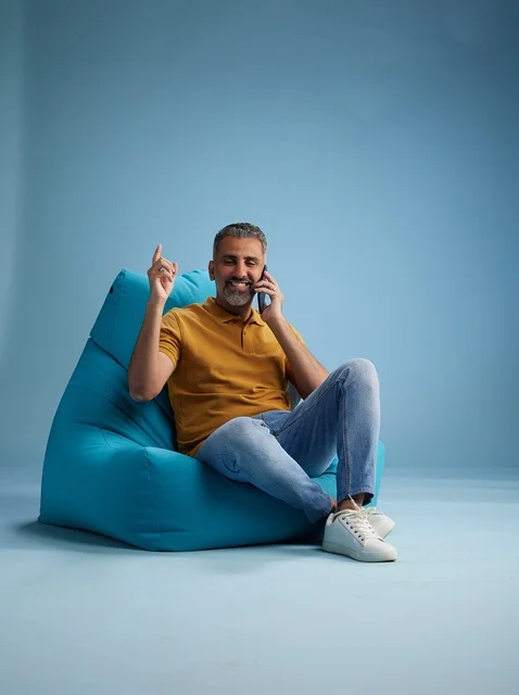 Saudi Man Talking on Mobile Phone Sitting on Bean Bag