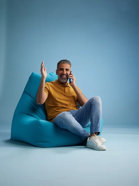 Saudi Man Talking on Phone on Bean Bag Chair