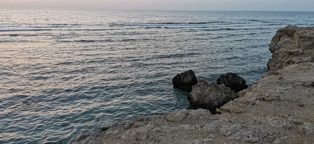 Rocky Coastline and Calm Sea Water Landscape at Dusk