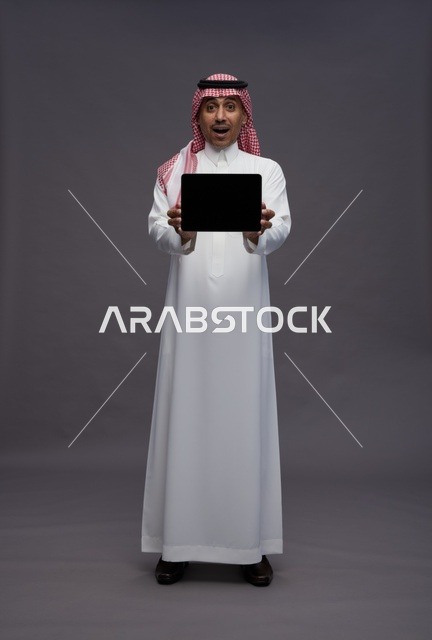 Surprised Saudi Man Holding Blank Digital Tablet