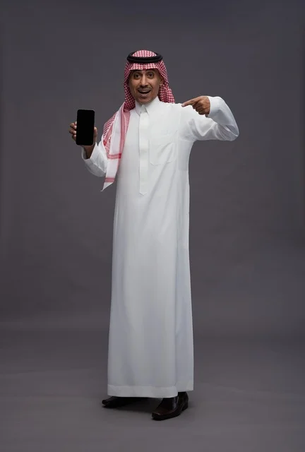 Saudi Man Holding Smartphone with Surprised Expression