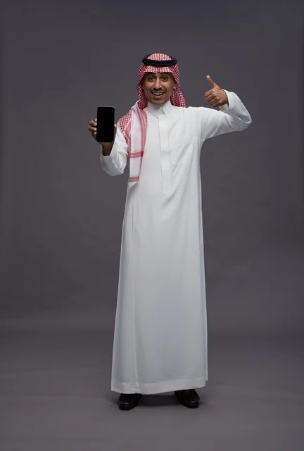 Saudi Man Holding Smartphone with Thumbs Up Gesture