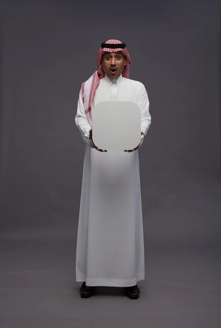 Surprised Saudi Man Holding Blank White Board