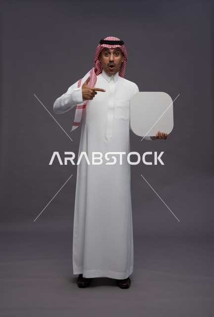 Saudi Man Pointing at Blank Sign with Surprised Expression